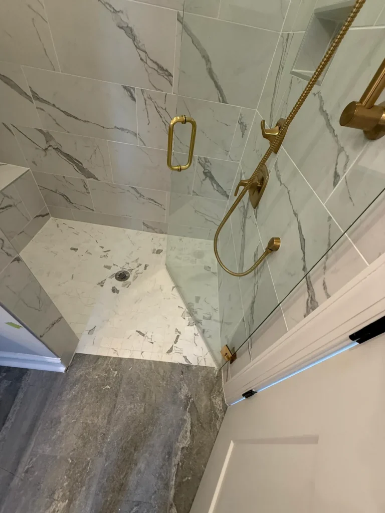 Curbless shower to floor transitioin by Seacoast Tile Pros
